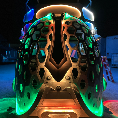 Dragonfly large-scale kinetic art car sculpture at Burning Man featuring illuminated wings and steel exoskeleton with LED lighting